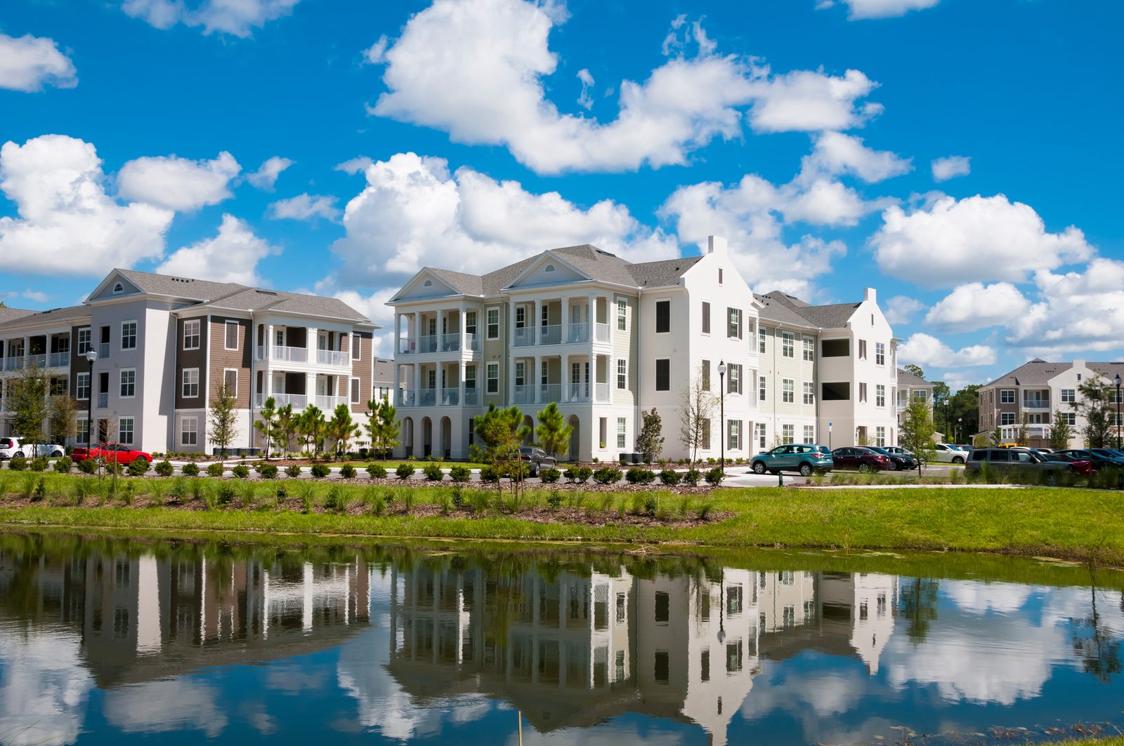 A garden-style apartment community beside a lake