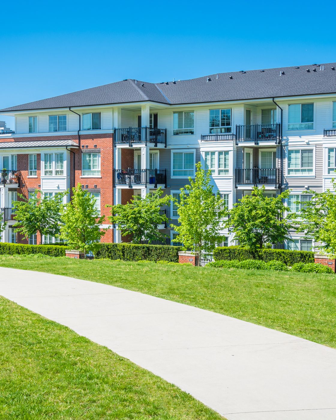 Lawns and walkways at a suburban garden-style apartment community