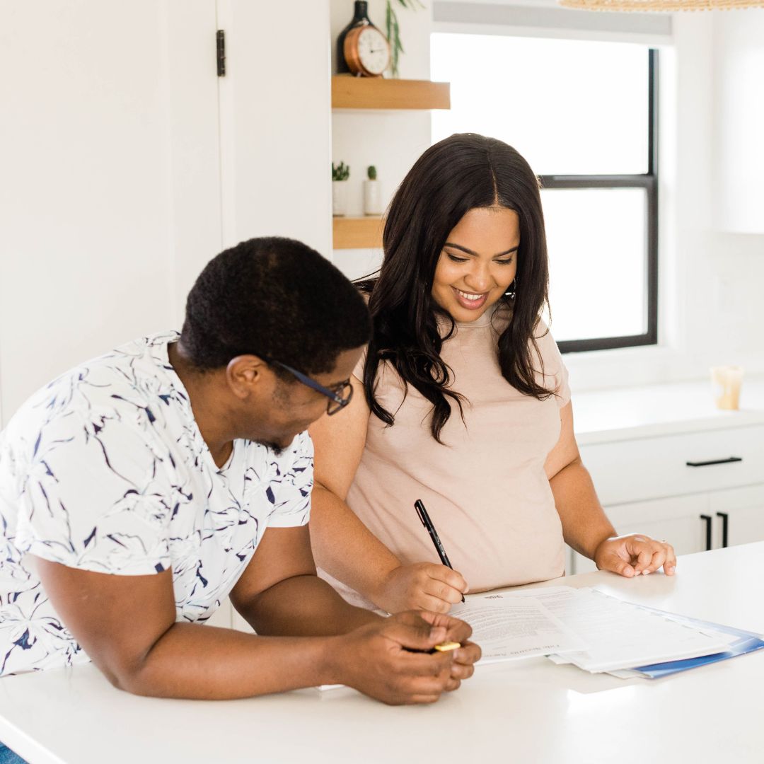 couple at counter signing papers